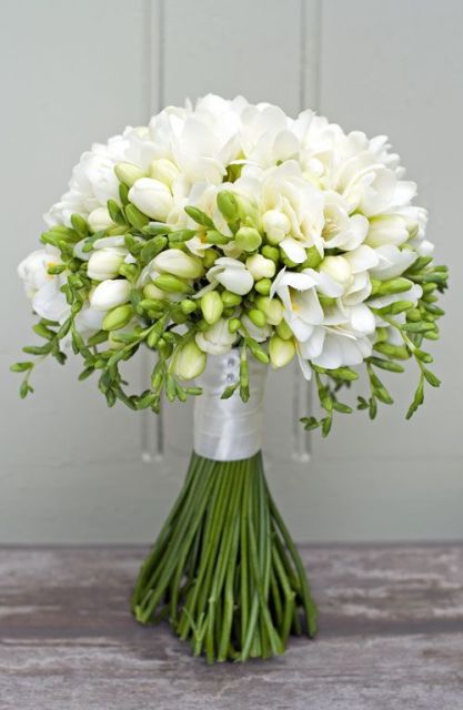 a white wedding bouquet of freesias and greenery is a lovely idea for an elegant and chic bride