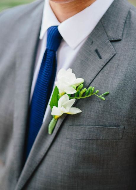 a lovely white wedding boutonniere with greenery is a chic and cool idea for a modern neutral wedding