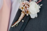 a delicate wedding boutonniere of a white bloom, cherry blossom, pale leaves is a lovely idea for a spring groom
