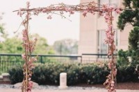 a lovely spring wedding arch with flowers