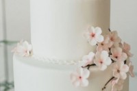 a white wedding cake decorated with cherry blossom is a chic and lovely idea for a spring wedding, it gives a lovely and delicate spring look to the wedding reception