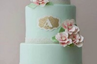 a mint wedding cake with lace ribbons, pink sugar blooms and a monogram is a cool and beautiful idea to rock in spring or summer