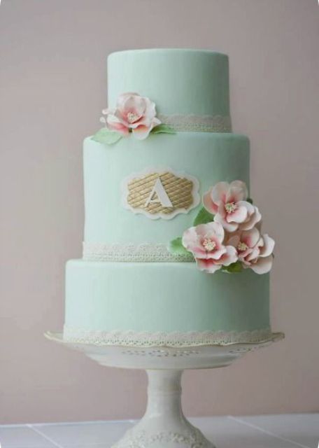 a mint wedding cake with lace ribbons, pink sugar blooms and a monogram is a cool and beautiful idea to rock in spring or summer