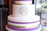 a bright striped wedding cake with purple and gold stripes and a gold monogram is a fun and bold idea of a spring or summer wedding