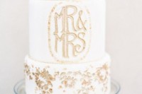 a white wedding cake decorated with gold leaf, with gold monograms is a very chic and beautiful idea to rock, it looks modern and pretty