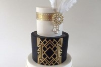 a contrasting black and white wedding cake with painted and embellished tiers, with a fringe tier and several feathers on top