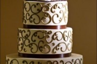 a patterned wedding cake with coffee mugs on top is amazing for a coffee-loving wedding couple