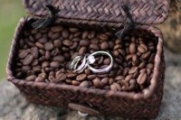 a woven basket with coffee beans and wedidng rings is a creative and cute idea to display them