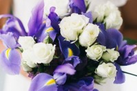 a pretty spring wedding bouquet of white garden roses and blue irises is a grogeous arrangement that you can DIY