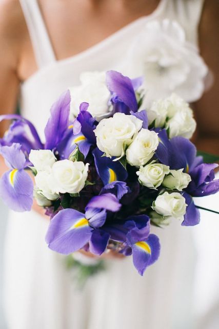 a pretty spring wedding bouquet of white garden roses and blue irises is a grogeous arrangement that you can DIY