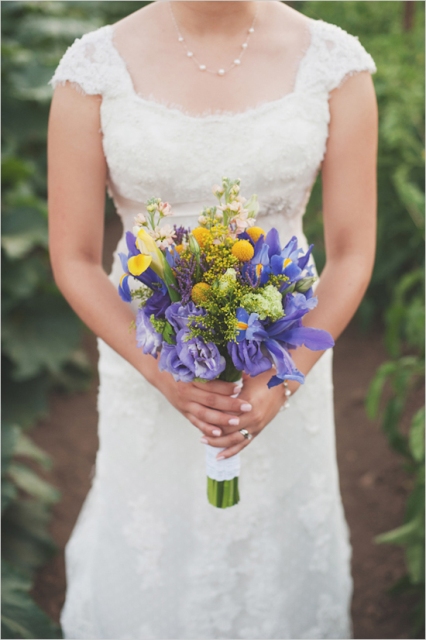 a bright wedding bouquet of blue irises, billy balls and some more purple bloos is a catchy idea for a spring or summer bride