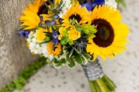 a bold rustic wedding bouquet of white blooms, sunflowers and some irises is a cool idea for a fun rustic wedding