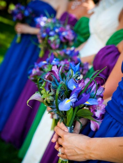 a bold blue iris wedding bouquet with some greenery is a great addition of color to your bridesmaids' looks