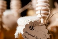 a honey jar with a personalzied tag and a burlap cover it a lovely idea for a wedding, you can make as many favors as you like