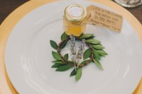 place honey jars with personalized tags and greenery right on the plate to give them as favors at your wedding