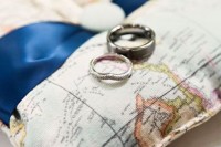 a map pillow for rings is a nice alternative to a bowl and it embraces the theme of the wedding