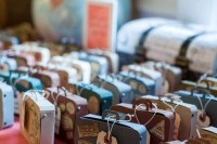 mini cardboard suitcases with favors inside are amazing for a travel-themed wedding