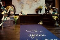 a travel-themed wedding backdrop with a map, a globe, paper air planes and flowers