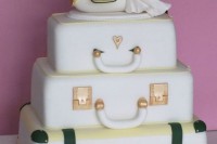 a unique wedding cake composed of suitcases and a plane with cake toppers is a fun idea for a travel-themed wedding