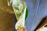 a map boutonniere with fabric blooms is a cool accessory for a travel-themed wedding, for grooms and groomsmen