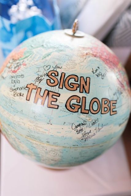 a globe to sign is a fresh and cool alternative to a wedding guest book, perfect for a travel-themed wedding