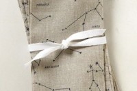 neutral constellation napkins with a white ribbon is a cool and edgy idea for a galaxy or astronomy wedding