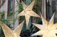 hang some lit up stars as lamps and lights to make your reception or ceremony space cozier and cooler