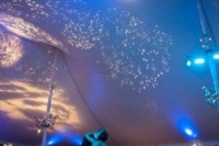 a reception ceiling done with stars and a moon is nice for decorating an astronomy wedding