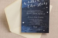 a navy wedding invitation with stars and a neutral envelope is a stylish idea for a celestial wedding