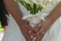 a white calla wedding bouquet with a white wrap and a white horseshoe for a rustic bride