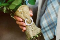 a burlap bouquet wrap with pearl buttons and a horseshoe is a nice idea for a rustic wedding