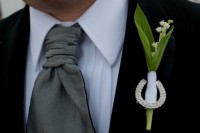 a unique and elegant wedding boutonniere of lily of the valley and a rhinestone horseshoe will fit any groom