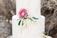 a neutral marble wedding cake with pink blooms and lily of the vally for a tender and cool spring wedding