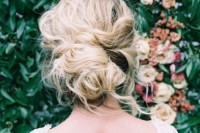 a messy low updo with a bump on top and some locks down is a chic idea for a modern and casual bride