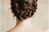 a twisted and braided low updo with a volume and texture on top for a boho or rustic bride