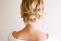 a messy twisted low bun plus locks down is a stylish and romantic idea for a casual modern bride