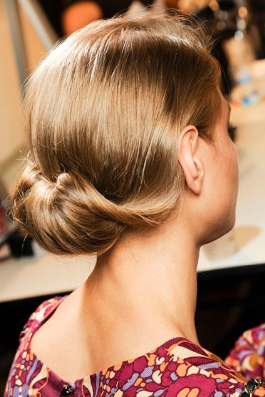 a very elegant retro inspired low updo with a bump on top is a chic idea for a retro bride