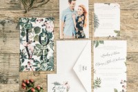 a stylish modern botanical wedding invitation suite with a floral invite, neutral envelopes with prints and a couple photo