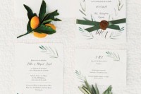 a lovely and ethereal wedding invitation suite with beautiful botanical patterns painted and green ribbon with a seal is a chic idea