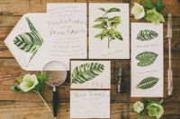 a bright botanical wedidng invitation suite includes lots of leaf prints and some blooms to show off the theme of the wedding