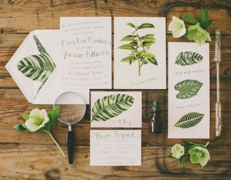 a bright botanical wedidng invitation suite includes lots of leaf prints and some blooms to show off the theme of the wedding