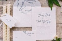 a subtle wedding invitation suite in white and blue, with botanical prints and calligraphy is a delicate idea