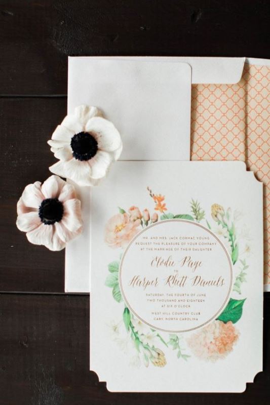 a chic wedding invitation suite with delicate peachy blooms and leaves and a cool envelope with stylish lining