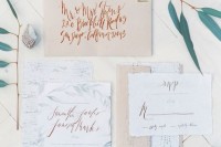 a neutral wedding invitation suite with neutral botanical prints, ivory envelopes and polka dot touches