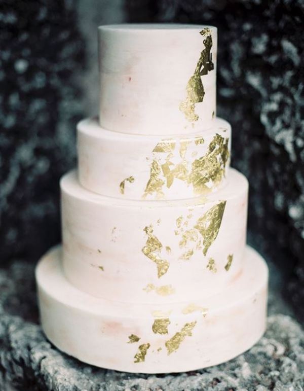 a light pink watercolor wedding cake decorated with gold leaf is a chic idea for a spring or summer wedding