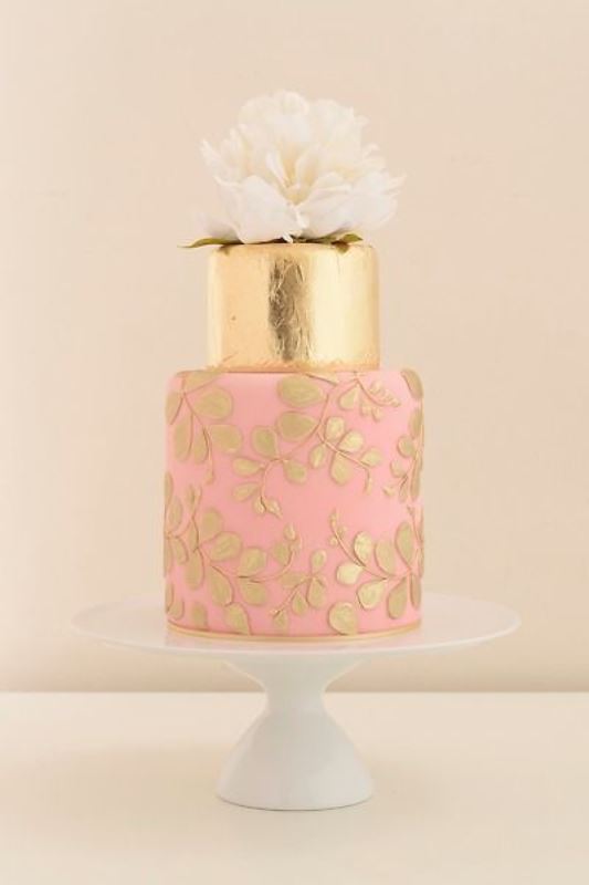 a bright wedding cake with a gold leaf tier and a pink one with gold leaf blooms plus a statement white bloom on top