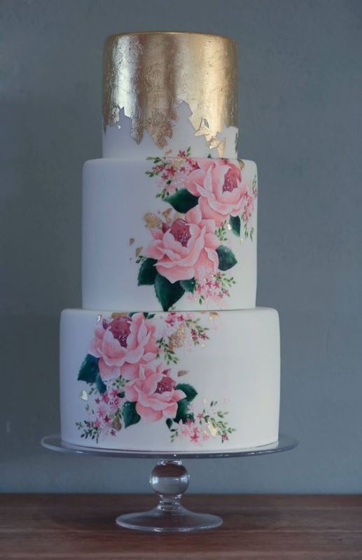 a white wedding cake accented with gold leaf and handpainted with bright blooms is a chic idea for summer