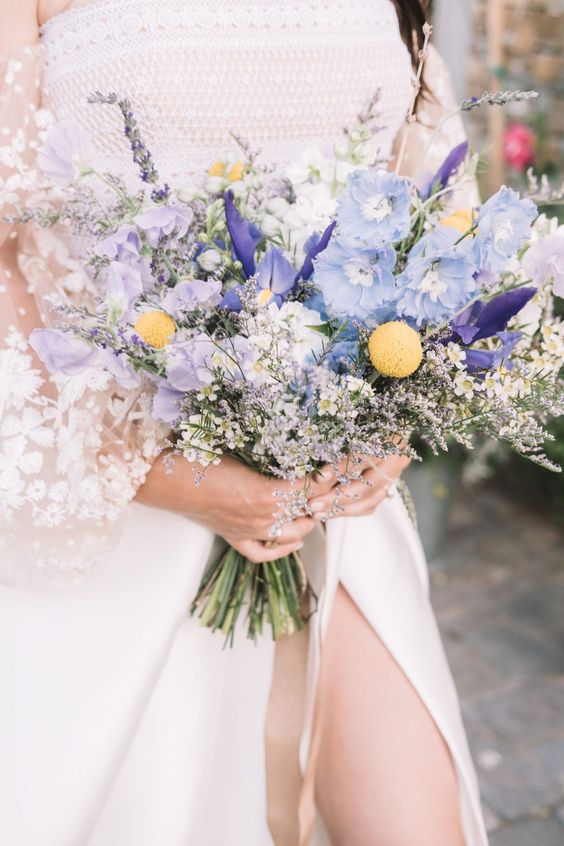 a beautiful and dreamy wedding bouquet with billy balls, blue irises, waxflower and dried blooms and grass is a chic idea to rock