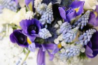 a beautiful pring bridal bouquet filled with muscari, iris, ivory spray roses and baby’s breath looks amazing and strikes with its color