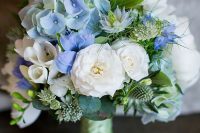 a beautiful wedding bouquet of white and serenity blue blooms, greenery and thistles plus a green ribbon is a chic idea for a spring or summer bride